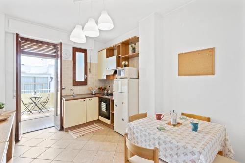 a kitchen and dining room with a table and a table and chairs at Aci Castello Seaview Apartment with Parking in Aci Castello