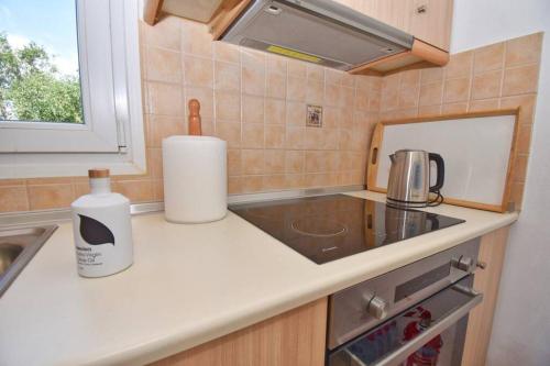 a small kitchen with a sink and a counter top at Villa Menethea Sea View - 5min from Issos beach in Línia