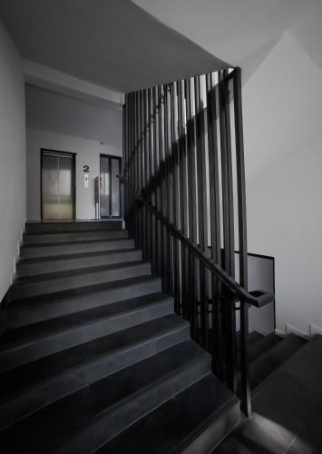 an empty stairway in a building with black railing at iWualai Hotel in Chiang Mai