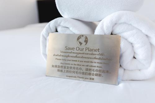 a sign that says save our planet with a towel at iWualai Hotel in Chiang Mai