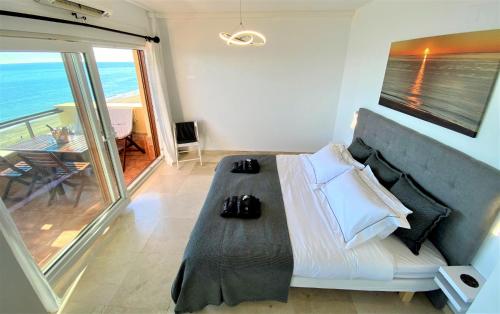 a bedroom with a bed with a view of the ocean at Los Reales 8B in Estepona