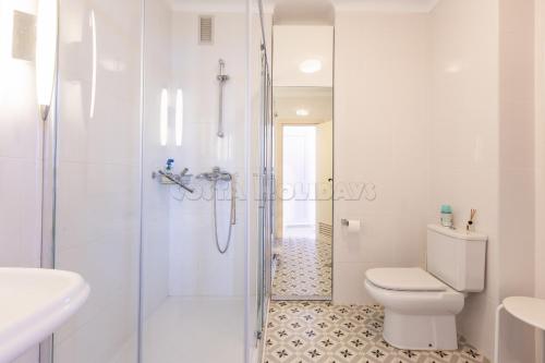 a bathroom with a shower and a toilet and a sink at Los Reales 8B in Estepona