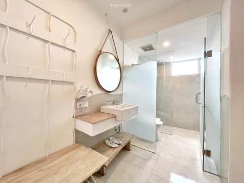 a bathroom with a sink and a mirror at Khaiyyara Jimbaran Bali in Uluwatu