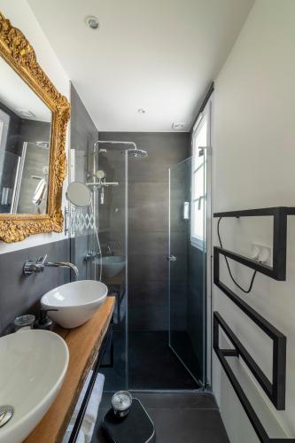 une salle de bain avec une douche, un lavabo et un miroir dans l'établissement MaisondesChaumes-Paris, à Paris