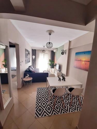 a living room with a table and a couch at Sweet Apartment in Thessaloniki