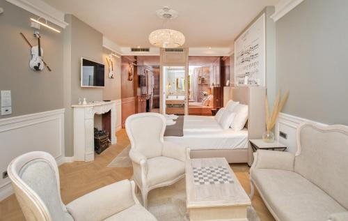 a living room with a white couch and chairs at Heritage Villa Nobile in Dubrovnik