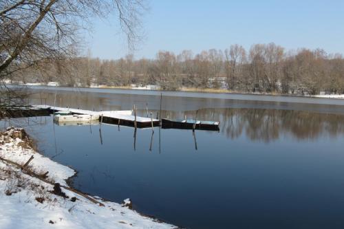 a lake with two boats in the water at TITI House in Bakonykoppány