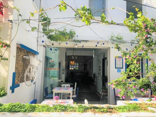 a house entrance with a table and chairs at Denizati Pension in Bodrum City