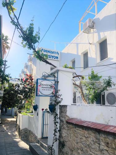 a street sign on the side of a white building at Denizati Pension in Bodrum City