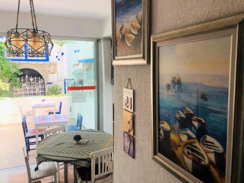 a dining room with a table and a picture on the wall at Denizati Pension in Bodrum City