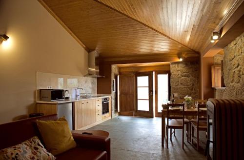 a living room with a kitchen and a dining room at Quinta de S. Cipriano in Resende
