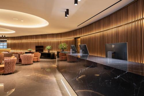 a lobby with a long counter in the middle of a room at Eurostars Aliados in Porto