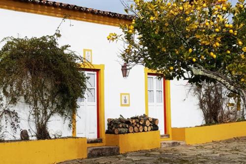 una casa con un montón de leña delante de ella en Monte da Tarouca no Alto Alentejo en Portalegre