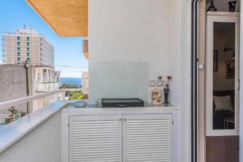 a balcony with a white counter and a window at Chic apartment Zoja near beach with free parking in Makarska