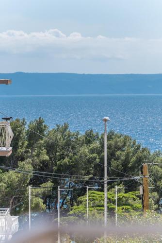 a view of the ocean with a street light at Chic apartment Zoja near beach with free parking in Makarska
