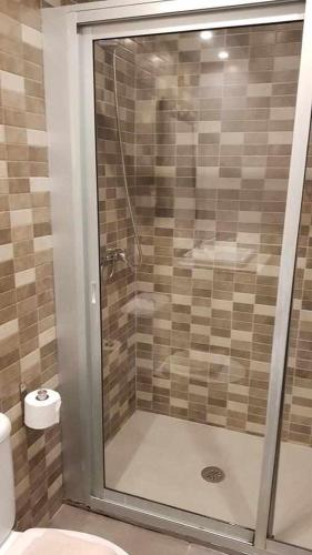 a glass shower in a bathroom with a toilet at Apartamento Perseo in Corralejo