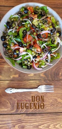 a salad in a bowl on a wooden table at La Casa del General Hotel Boutique in Hidalgo del Parral