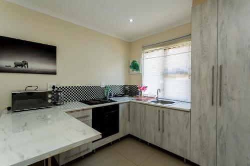 a kitchen with a sink and a counter top at The Beverly in Johannesburg