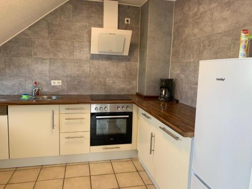 a kitchen with a sink and a stove at Casa Blanca 3 in Ottenheim