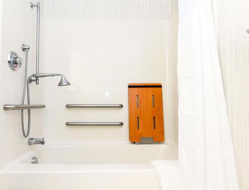 a bathroom with a bath tub with a wooden block in it at Holiday Inn Express Ashland by IHG in Ashland