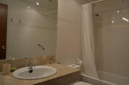 a bathroom with a sink and a shower and a toilet at Apartament Duplex Camprodon in Camprodon