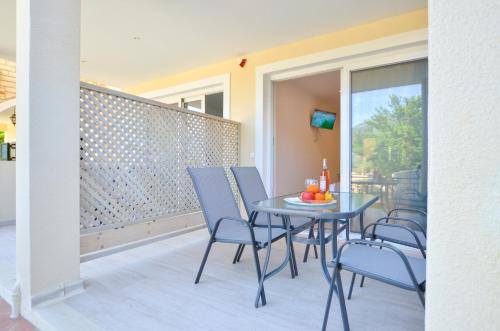 a blue table and chairs on a balcony at Meltemi Studios in Vasiliki
