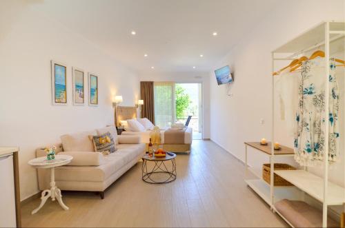 a living room with a couch and a table at Meltemi Studios in Vasiliki