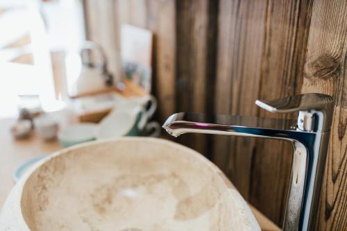 a sink in a bathroom with a faucet at Boutique Apartment Sonnenhang - incl InfinityPOOL in Fliess