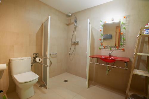 a bathroom with a shower and a toilet and a sink at Casa Mamina in Siero