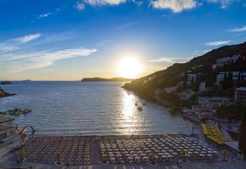 a view of a body of water with the sun setting at Hotel Dubrovnik in Dubrovnik