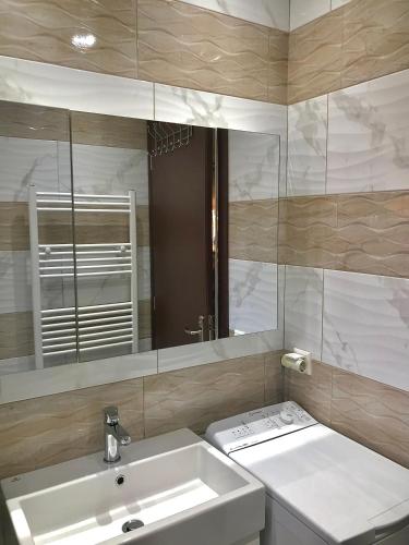 a bathroom with a sink and a mirror at Nikos Apartament in Prinos