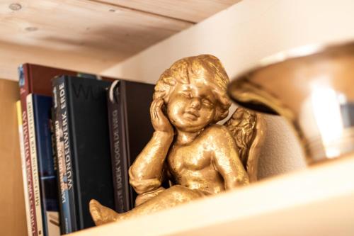 a bronze statue of a child sitting on a shelf at Chalet Steingärtli 1 in Wengen