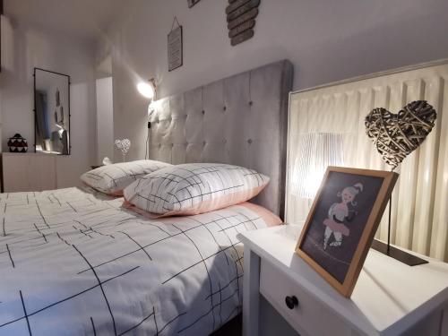 - une chambre avec un lit et une photo sur une table dans l'établissement New Duplex de charme au pied de la Cathédrale Carré d'or, à Strasbourg