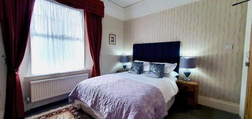 a bedroom with a large bed and a window at Marmalade Bed & Breakfast in Torquay
