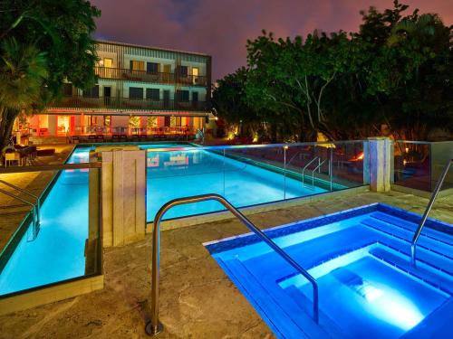 a swimming pool at night with a hotel at AxelBeach Miami South Beach - Adults Only in Miami Beach