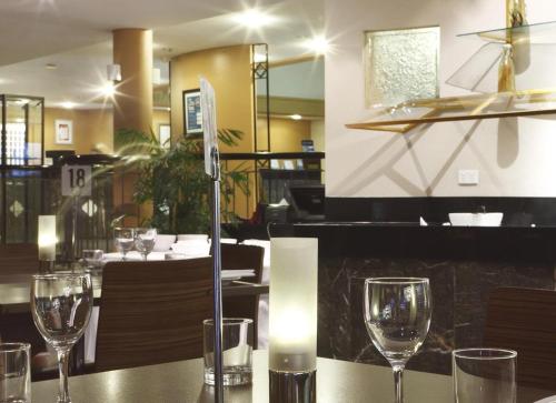 a table in a restaurant with wine glasses on it at ibis Styles Canberra in Canberra