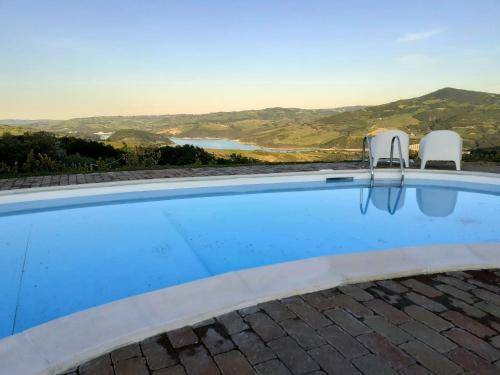 a swimming pool with a view of the ocean at Le Terre Del Sacramento in Guardialfiera