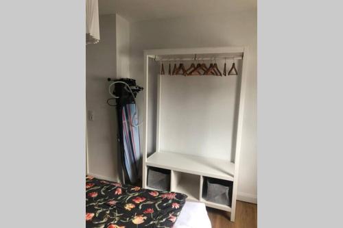 a small white refrigerator in a room at 5-Zi. Wohnung in Bahnhofsnähe - 24/7 self-check-in in Borstel