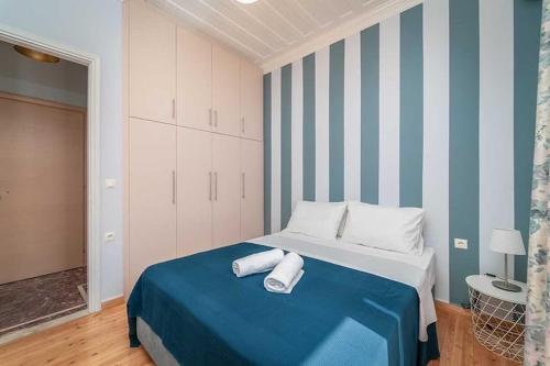 a bedroom with a bed with two towels on it at Sivylla Apartments in Lefkada