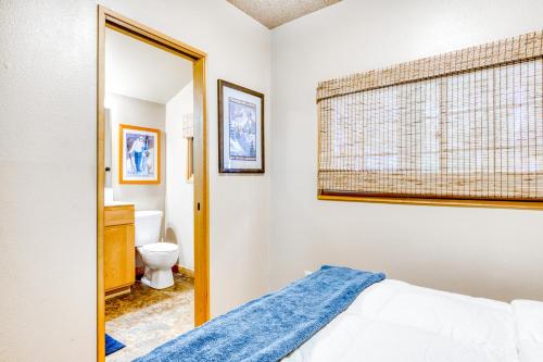 a bedroom with a bed and a toilet at Huckleberry Haven in Rhododendron