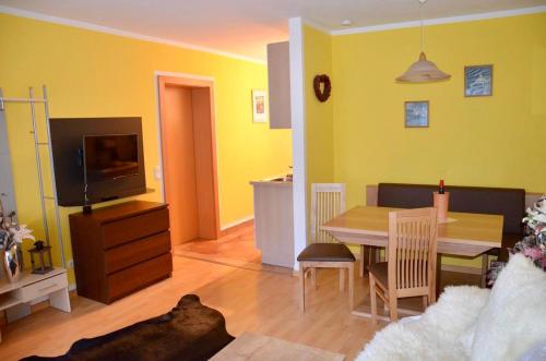 a living room with a table and a dining room at Haus Bodner-Scherer in Mühlbach am Hochkönig