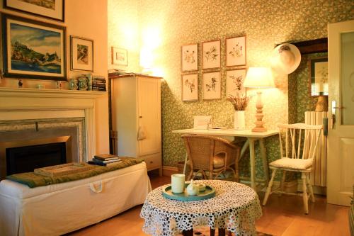 uma sala de estar com uma lareira e uma mesa em Alle Rive Bed'n'Books Apt em Calamandrana