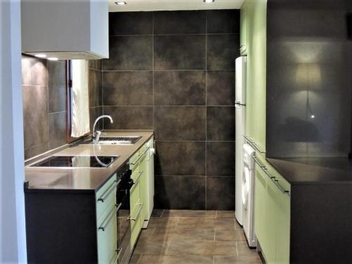 a kitchen with a sink and a refrigerator at Casa Rural Vistes de Morella in Morella