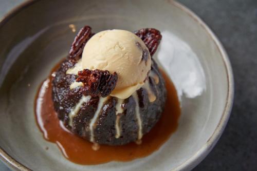 a dessert with a scoop of ice cream on a plate at The Langford Inn in Langford