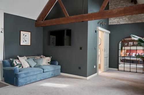 a living room with a blue couch in a room at The Langford Inn in Langford