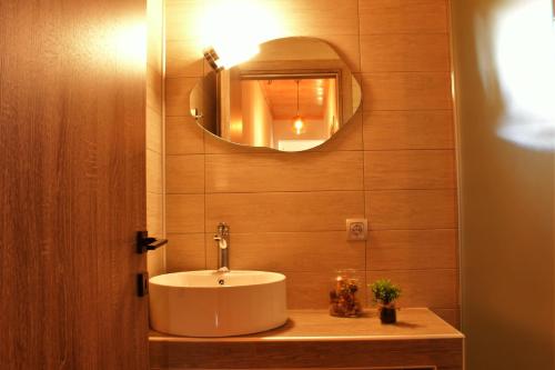 a bathroom with a sink and a mirror at Ktima Mimoza in Sikia