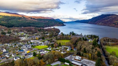 an aerial view of a town next to a lake at Loch Ness Highland Resort in Fort Augustus