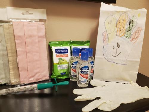 a table with two bottles of detergent and a pair of gloves at Sunny Central Apartment in Sofia