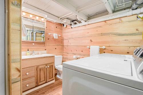 a bathroom with a sink and a washer and dryer at Anna's Cottage in Saugatuck