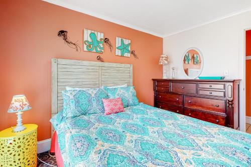 a bedroom with a bed and a wooden dresser at Brooklyn's Casa Rosa & Hitch Apartment in Ocean City